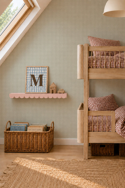 A children’s room with a wooden bunk bed, a scalloped pink wall shelf displaying a framed letter M, and a wicker basket filled with storybooks against Mini Check Wallpaper Sample, Green.