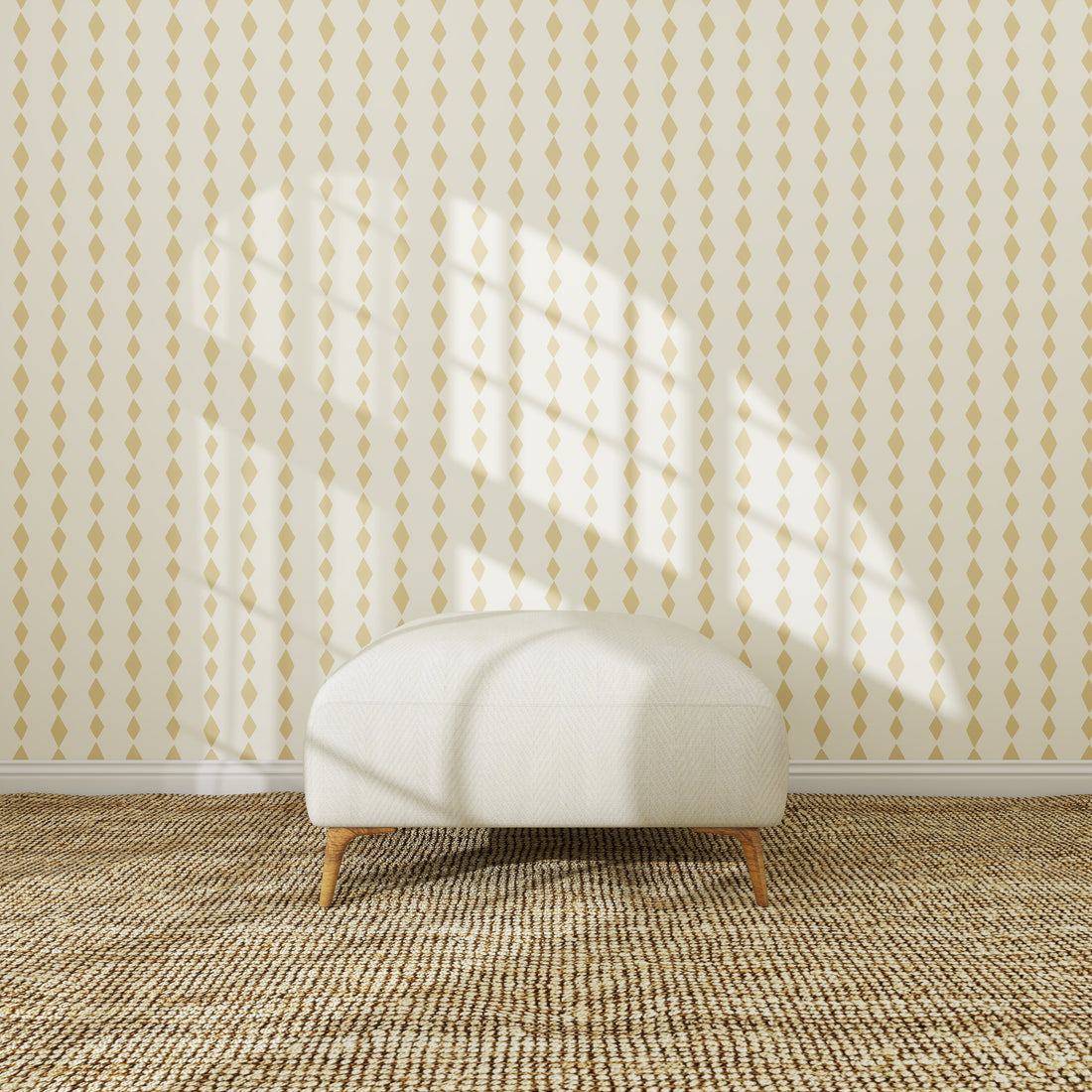 A white, round ottoman sits on a textured woven rug in front of the Jolly Jester Wallpaper Repeat Yellow sample. Sunlight streams through a window, casting geometric shadows that highlight the wallpaper’s quality.