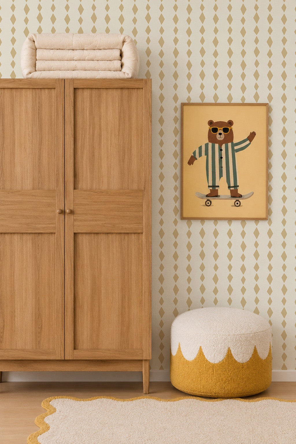 A wooden wardrobe stands beside a round pouf with a white and yellow pattern. Above it hangs a framed picture of a bear in pajamas on a skateboard. The wall features Jolly Jester Wallpaper, Yellow, adding playful charm.