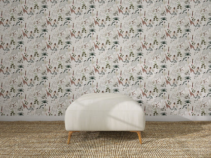 A white upholstered ottoman sits on a woven rug in front of a wall decorated with Jungle Dreams Wallpaper Repeat Pattern, showcasing colorful botanical and animal designs.
