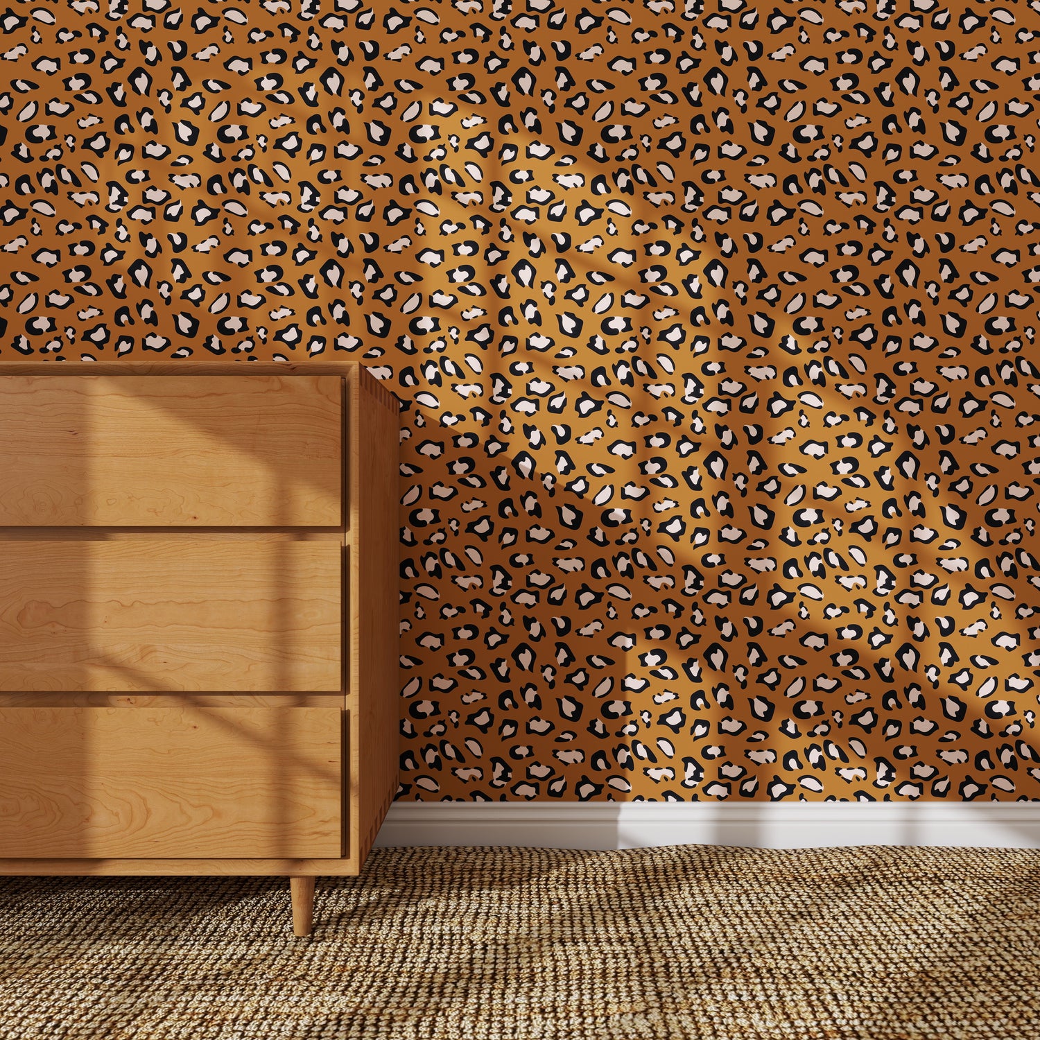 A wooden dresser stands on a woven rug next to a wall covered in Leopard Print Wallpaper Repeat Pattern, the bold brown and black design adding dramatic flair to the room.