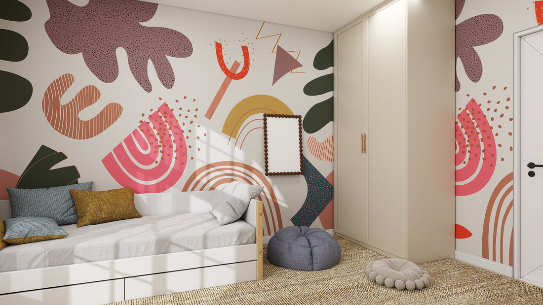 A modern bedroom featuring a white bed, beige wardrobe, gray pouf, round cushion, decorative pillows in neutral and blue tones, and bold wall decor with the Little Erin Abstract Wallpaper Mural.