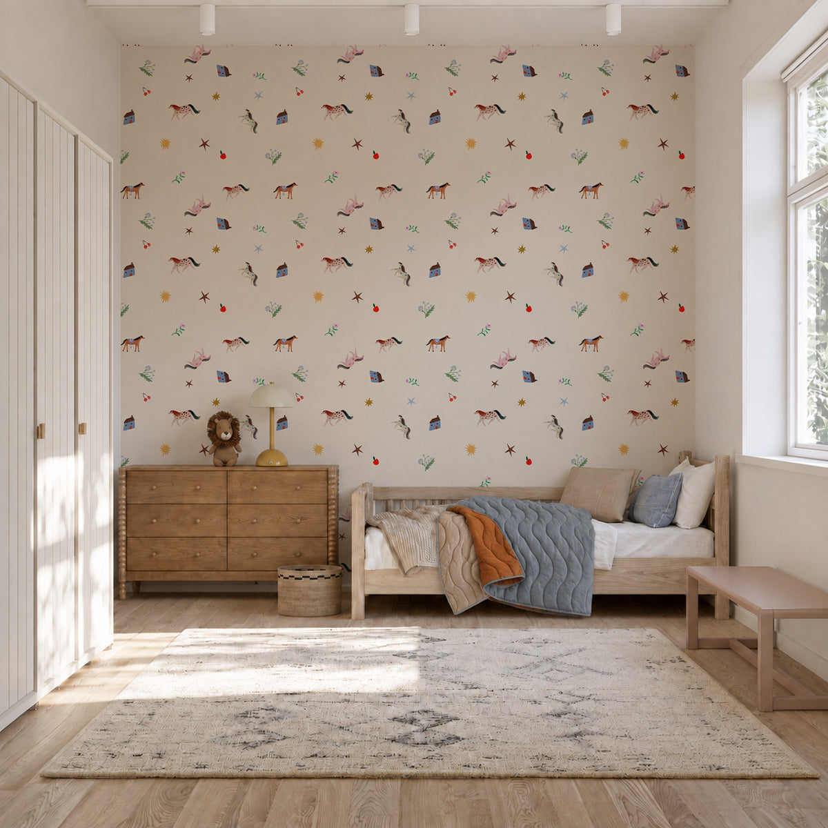 A child’s bedroom featuring Little Paddock Wallpaper with small illustrations of horses, houses, stars, and foliage.