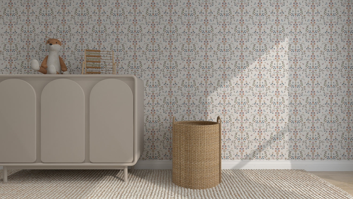 A nursery with Forest Tales Wallpaper Repeat Pattern, a light beige dresser holding a plush fox and an abacus, and a woven wicker basket on a textured rug. Sunlight casts soft shadows on the wall.
