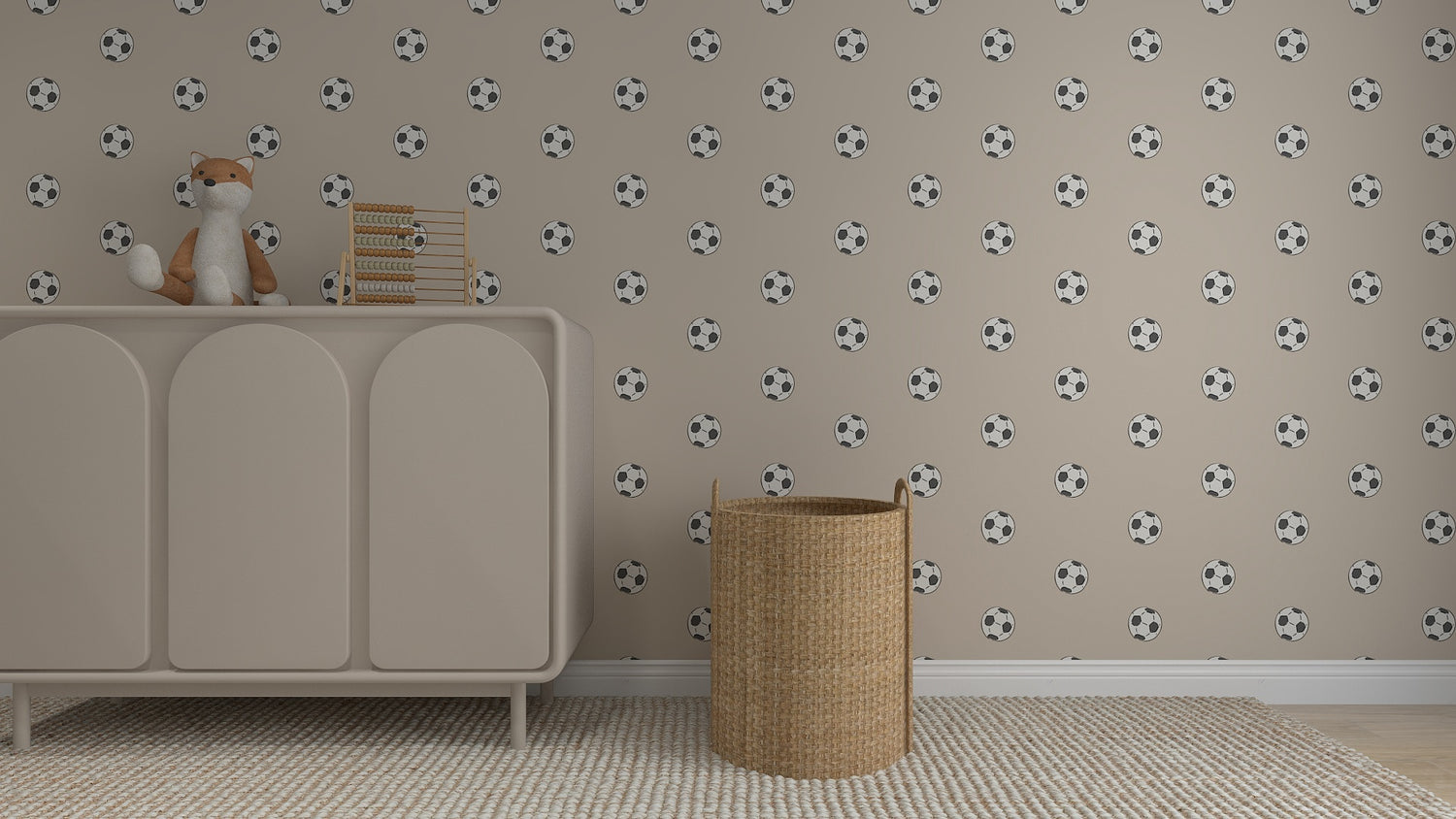 A nursery room features the Its All About Footballs Repeat Pattern beige wallpaper, a light dresser with a plush fox and abacus, a woven basket, and a textured rug—perfect for little sports fans.