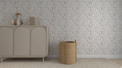 A neutral-toned nursery features a beige dresser, plush fox toy, stacked books, a woven laundry basket, and is finished with Millie Floral Wallpaper Repeat Pattern in soft pastel florals for an elegant touch.