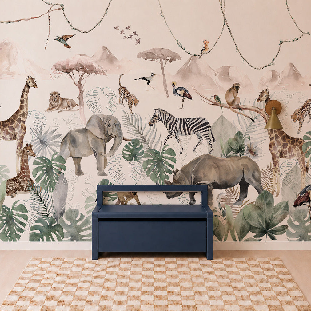 A children’s room featuring the Paradise Jungle Mural, an illustrated wallpaper showcasing jungle animals like giraffes, elephants, lions, zebras, and birds surrounded by lush leaves, paired with a blue bench and a checkered rug on the floor.