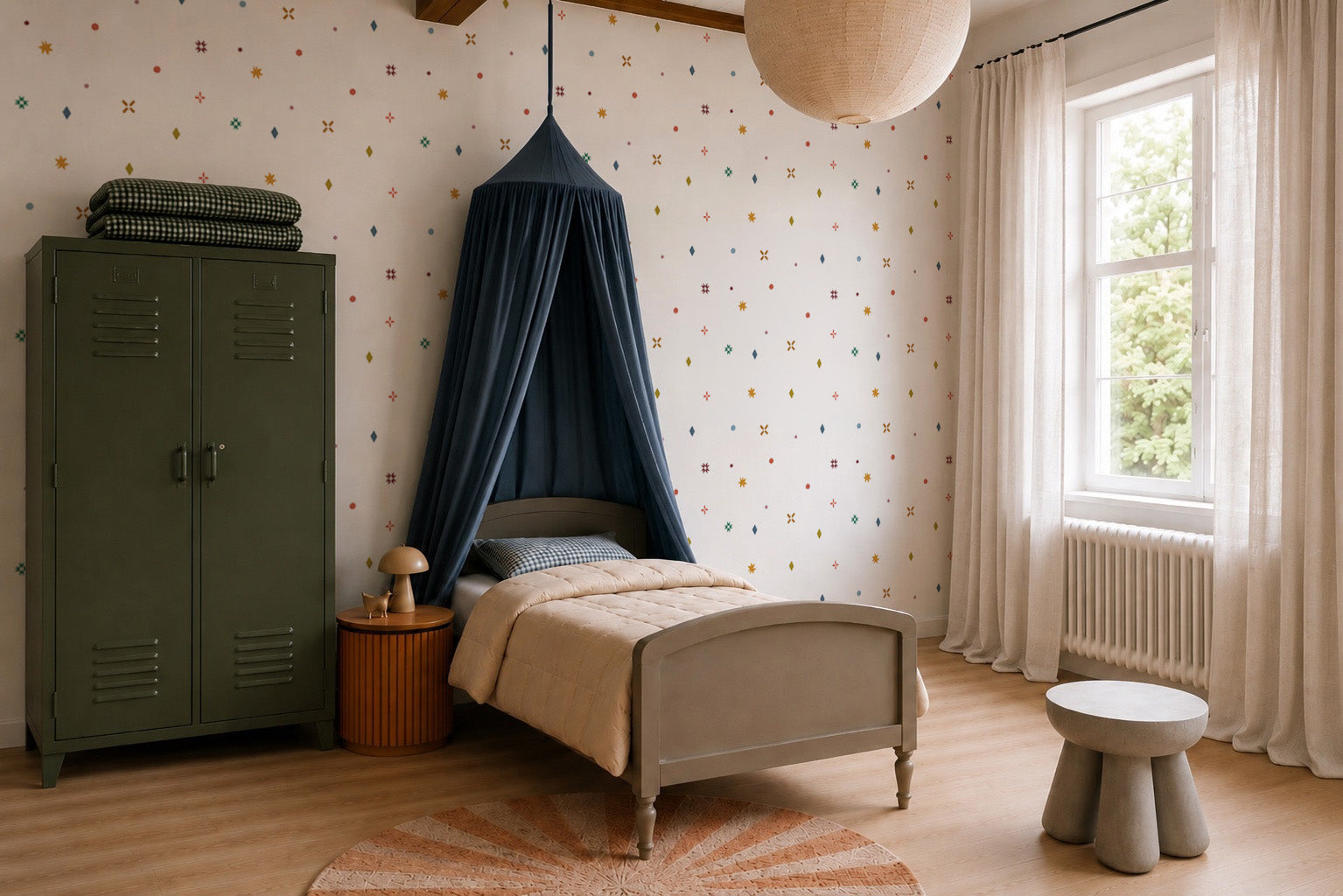 Sure! Here’s the revised sentence that incorporates the given product name: Cozy children’s bedroom with a single bed under a navy canopy, green locker-style wardrobe, round rug, small side table, and large window with sheer curtains. The walls are adorned with Pebble and Patch Wallpaper in Multi, featuring colorful, playful dot patterns reminiscent of abstract minimalist design and adding a modern touch to this inviting space.