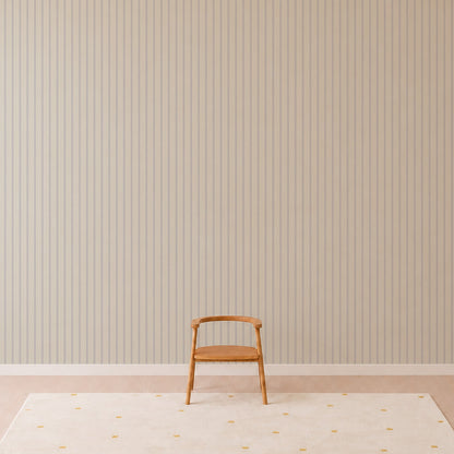 A single wooden chair sits on a light carpet with yellow dots, in front of a wall covered with Pinstripe Wallpaper Sky. The scene is minimalist and uncluttered.