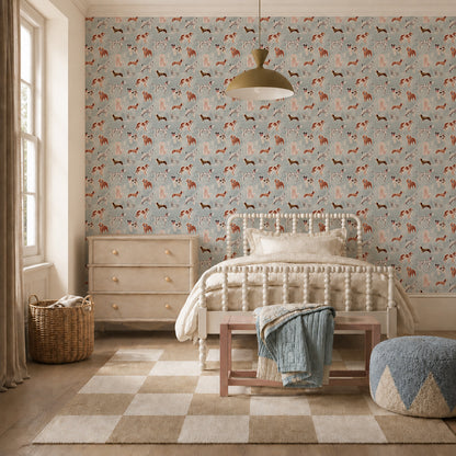 A furnished bedroom featuring Rigby Dog Print Wallpaper, Blue, with a repeating pattern of various dog breeds in shades of brown, white, and tan.
