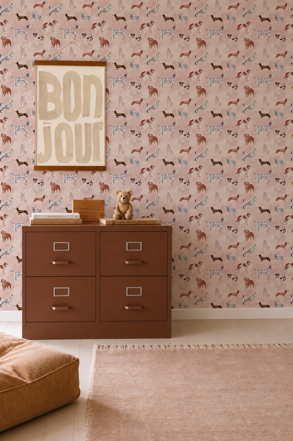 A brown four-drawer filing cabinet sits in front of Rigby Dog Print Wallpaper, Rose, which features small illustrations of various dog breeds.