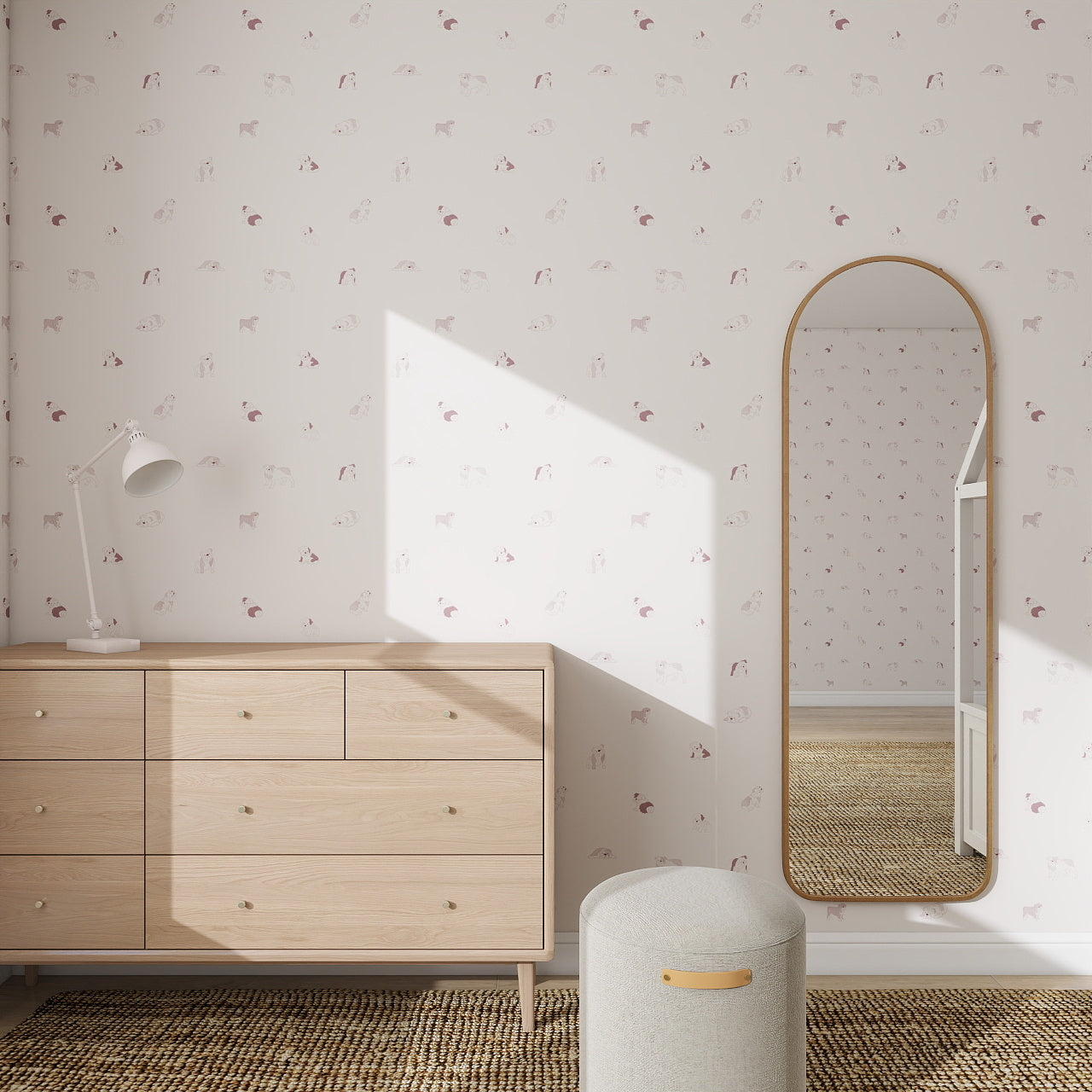 Minimalist bedroom with a light wood dresser, white lamp, oval wall mirror, textured beige ottoman, and Ruffles Bull Dog Wallpaper Repeat Pattern | Rose. Sunlight casts geometric shadows on the pastel floral wallpaper.
