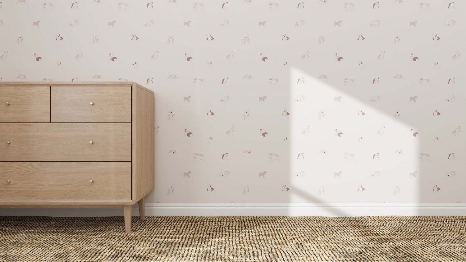 A light wood dresser with four drawers stands on a woven tan rug by a wall decorated with Ruffles Bull Dog Wallpaper Repeat Pattern | Rose. Sunlight casts a triangle-shaped shadow, adding charm to the cozy scene.