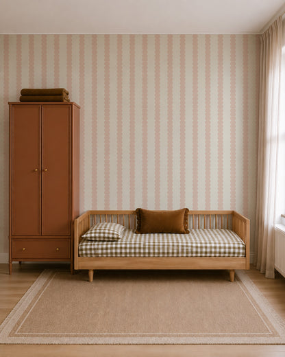 Scallop Stripe Wallpaper, Blush featuring a vertical pattern of blush pink scalloped stripes on a light background.