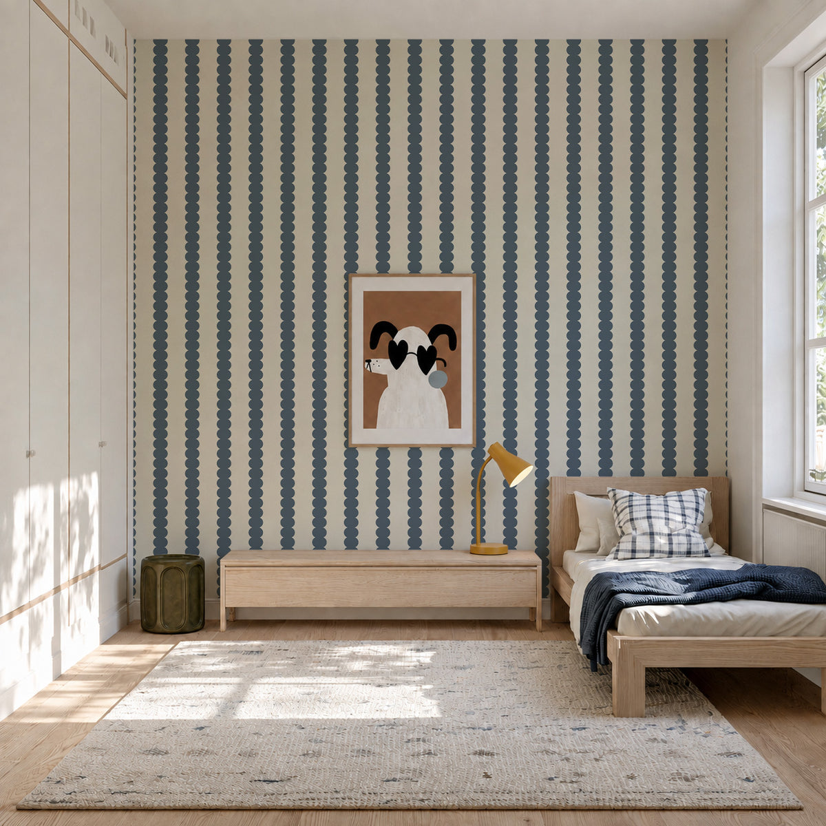 A bedroom wall featuring Scallop Stripe Wallpaper, Deep Blue, with vertical scallop stripe patterns in deep blue.