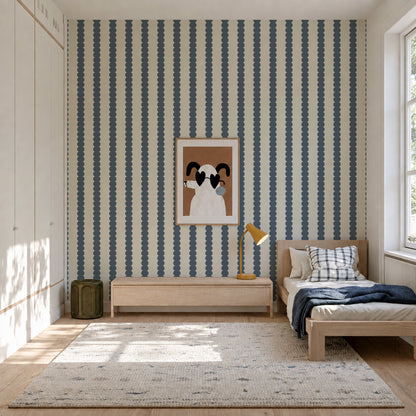 A bedroom wall featuring Scallop Stripe Wallpaper, Deep Blue, with vertical scallop stripe patterns in deep blue.