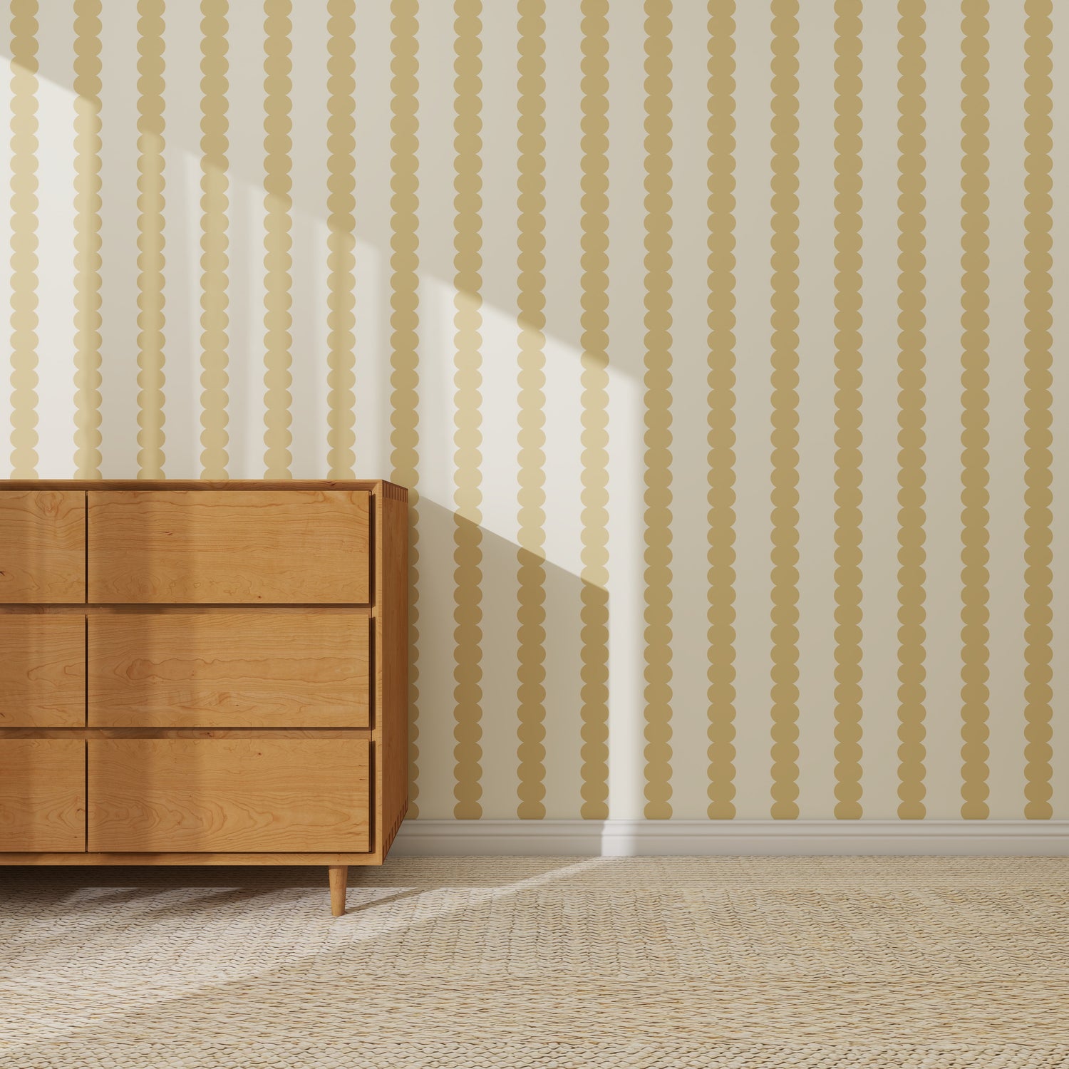 A wooden dresser with six drawers stands on a woven rug against a wall covered in Scallop Stripe Wallpaper Sample, Yellow. Sunlight streams in, casting diagonal shadows that accentuate the wallpaper’s unique yellow and beige stripes.