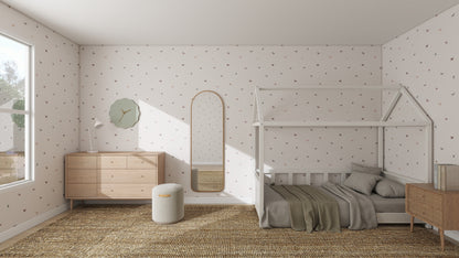 A minimalist child’s bedroom features a bed shaped like a small house, light wood furniture, and a tall mirror. Soft natural light highlights the Bibi Butterflies Wallpaper Repeat Pattern with whimsical hand-drawn details on the white walls.