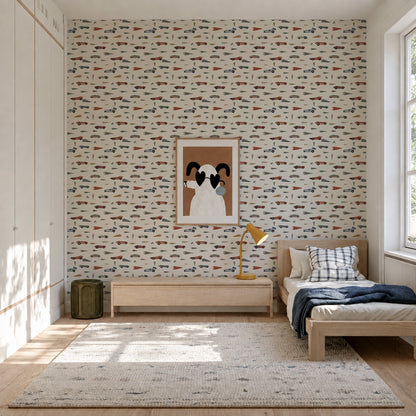 Speedway Dash Wallpaper featuring a repeating pattern of colorful vintage-style race cars on a white background, installed in a child’s bedroom with a single bed and a framed dog print.