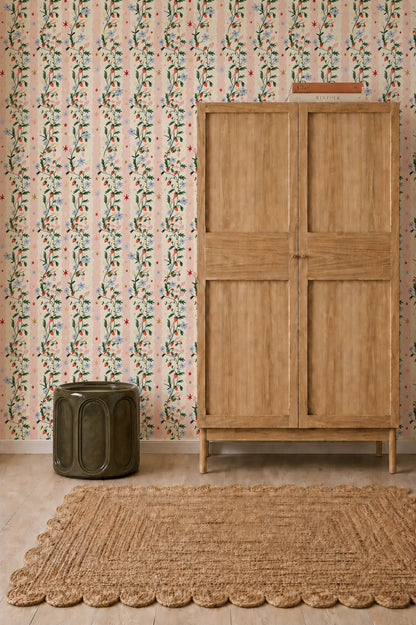 Strawberry Bloom Wallpaper sample featuring a repeating pattern of trailing vines, small blue flowers, and red strawberries over thin pink and white vertical stripes.