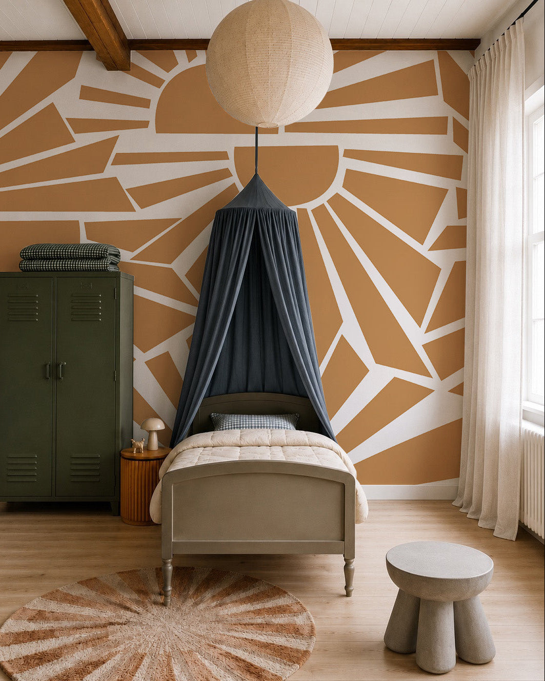 A cozy bedroom featuring a single bed under a dark canopy, green locker, round paper lantern, Sunbeams Mural as wall decor behind the bed, beige curtains, circular rug, and a small gray table with stool.