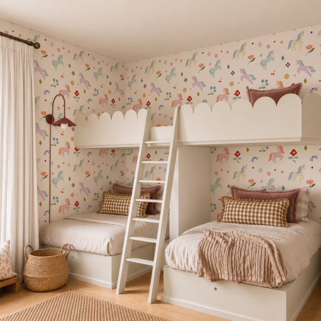 Children’s bedroom featuring two white bunk beds with pastel bedding, a wooden ladder, the Unicorn Party Wallpaper, a wicker basket, and a window with cream curtains for a cozy, whimsical vibe.