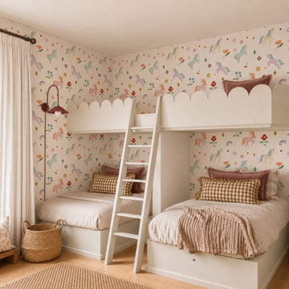 Children’s bedroom featuring two white bunk beds with pastel bedding, a wooden ladder, the Unicorn Party Wallpaper, a wicker basket, and a window with cream curtains for a cozy, whimsical vibe.