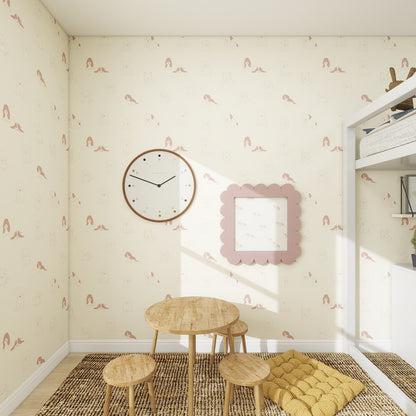 A cozy kids’ room with Custom Puppy Dog Wallpaper Repeat Pattern | Rose, a round wall clock, scalloped pink picture frame, small wooden table with stools, woven rug, yellow floor cushion, and a white bunk bed—perfect for stylish home decor lovers.