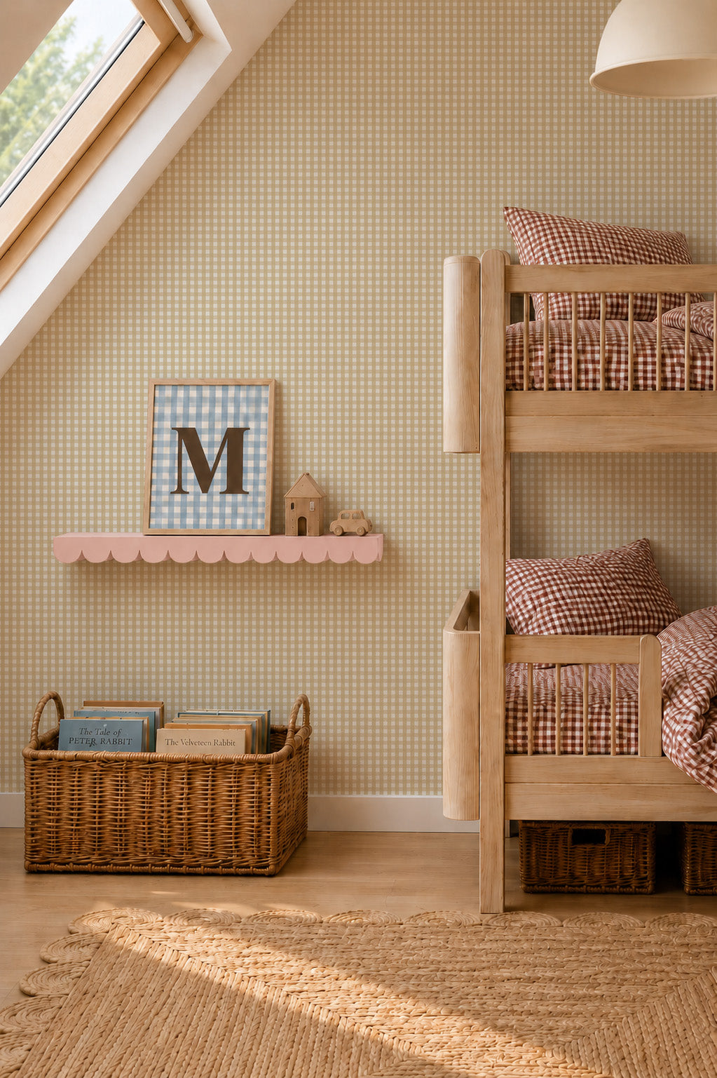A child’s bedroom featuring a wooden bunk bed with gingham bedding, a scalloped pink wall shelf holding a framed letter M and small wooden toys, and a wicker basket filled with books against a backdrop of Mini Check Wallpaper Sample, Yellow.