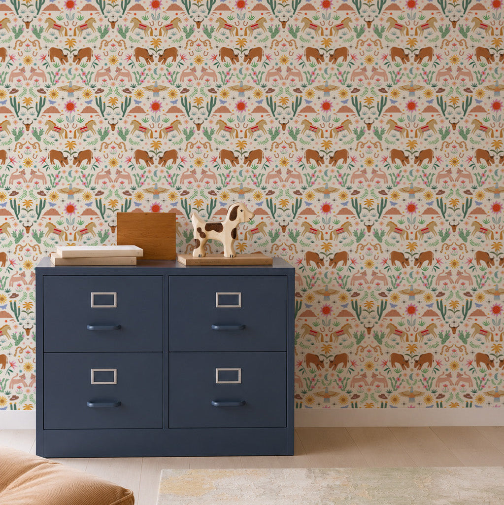 A blue four-drawer cabinet stands on a wooden floor, topped with wooden boxes and a decorative giraffe. The wall behind is adorned with the "You&